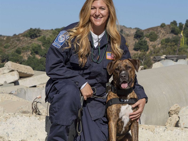 Search Dog Emmett with handler Kristine Priebe on rubble